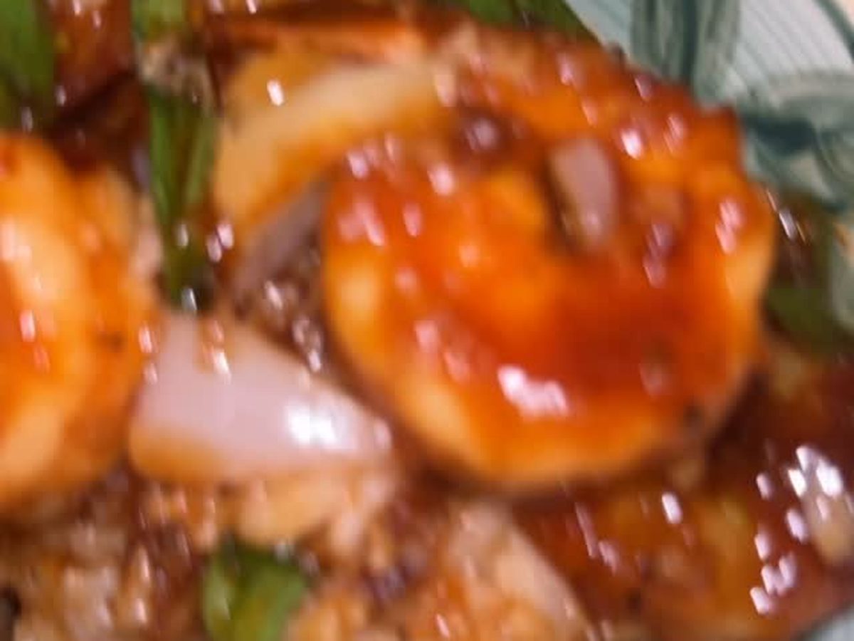 Glazed shrimp with sliced onions and scallions in a dark sauce